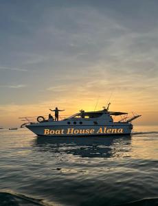 阿普里利亚马利蒂马Boat House Alena的站在水中的船上的男人