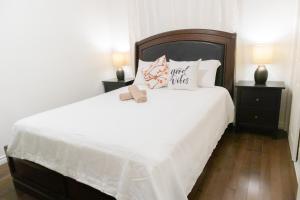 汉密尔顿Cozy Private Room-Your Perfect place in Hamilton的一间卧室配有一张带2个床头柜的大型白色床
