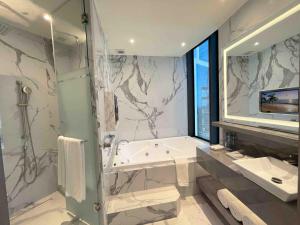 蒙特雷Safi Royal Luxury Metropolitan的带淋浴、浴缸和盥洗盆的浴室