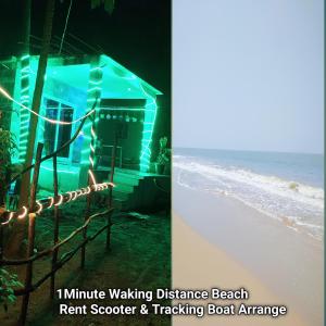 戈卡尔纳Somnath Bandekar Home stay In Beach Side AC Room的海滩上的房子,有灯光和海洋