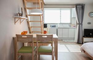 济州市Jeju Aria Pension的小房间设有桌椅和梯子