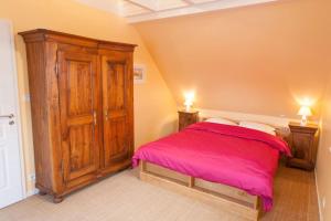 瑟温Doller Villa 4 stars Hot Tub Mountain Ski Ballon d'Alsace的一间卧室配有一张床和一个木制橱柜