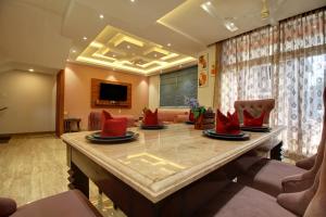 巴加Euphoria Luxury Villa - 5BHK - Private Pool - Jacuzzi, Baga的客厅配有带红色枕头的大桌子