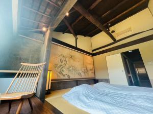 Giommachi京都　水凪庵　Kyoto Mizunagian的一间卧室配有一张床和一把椅子
