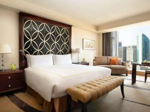 北京北京华彬费尔蒙酒店的酒店客房设有一张大床和一张沙发。