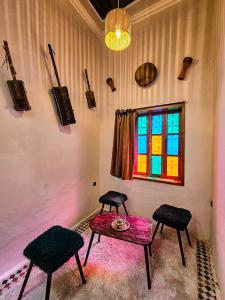 拉巴特DAR SABA的一间设有两把椅子、一张桌子和一个窗户的房间