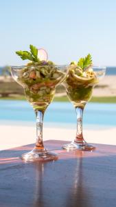 RecadoCasa Kundavi Beach Front Paradise的两杯装满餐桌上的食物的酒杯
