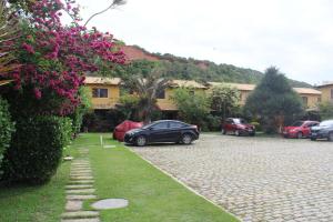 布希奥斯Casa em Búzios com Vista para o Mar的停在房子旁边的停车场的汽车