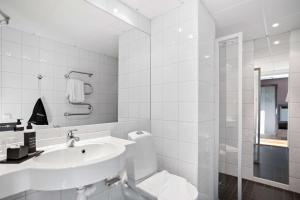 索尔纳Aiden by Best Western Stockholm Solna的白色的浴室设有水槽和淋浴。