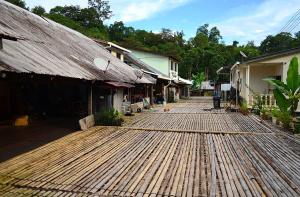 Kampong TengSteffan Family Stay的一组建筑旁边的木制走道