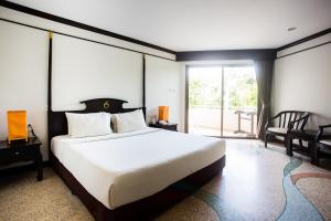 奥南海滩金海滩度假酒店的一间卧室设有一张大床和一个大窗户