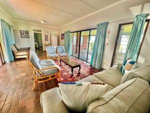 圣卢西亚St Lucia Holiday Cottage的客厅配有沙发和椅子