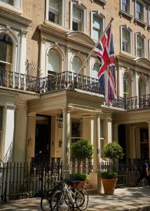 伦敦菲尔姆戴尔酒店集团骑士桥酒店的两辆自行车停在一座有英国国旗的建筑前