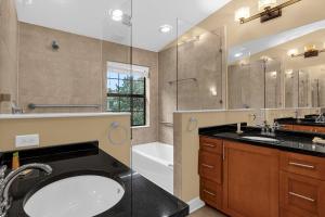 奥兰多4BR. Disney World Vacation Townhome的一间带水槽、浴缸和淋浴的浴室