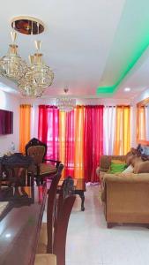 Licey al MedioCómodo apartamento en Santiago的客厅配有色彩缤纷的窗帘和沙发