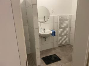 埃姆登Appartementhaus EMDEN的一间带水槽和镜子的浴室