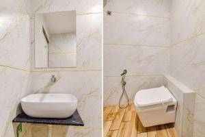 巴罗达FabExpress Md的浴室设有白色的卫生间和镜子