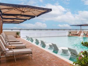 巴拿马城Sofitel Legend Casco Viejo, Panama City的一个带躺椅的游泳池和一个游泳池