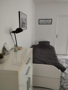 勒阿弗尔charmant studio canapé lit Netflix prime vidéo wifi的一间卧室配有一张床和一张带台灯的书桌