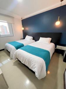 巴兰基亚Atlantis Suites Bquilla -Apartamento Moderno-2-BD的两张睡床彼此相邻,位于一个房间里
