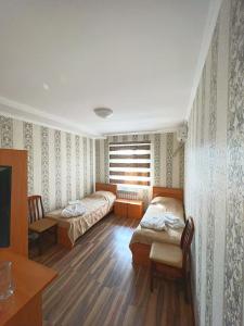 Санаторий Босага сарыагаш客房内的一张或多张床位