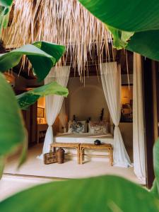 爱妮岛ALON Villas的树木间内一间卧室,配有一张床