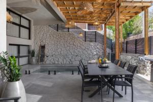 埃拉特Diamond in the Desert- for families的一个带桌椅和石墙的庭院