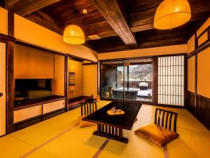 真庭市Yukai Resort Terunoyu的客厅配有餐桌和电视