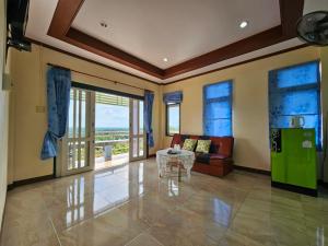 素叻Baan Khao Noi Resort的客厅配有沙发和桌子