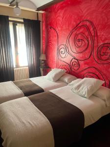 仕格莱The Garden by LUKE的红色墙壁的酒店客房内的两张床