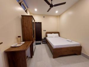 古瓦哈提Hotel Hari Gayatri Regent的一间卧室配有一张床和一张书桌
