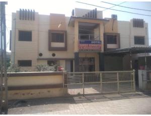 索姆纳特Hotel Shree, Somnath的前面有栅栏的建筑