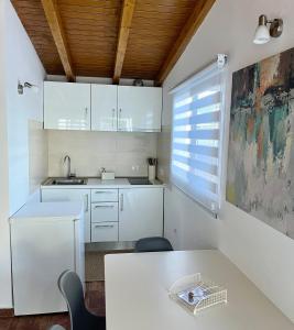 圣米格尔德阿沃纳Finca La Luz的厨房配有白色橱柜和桌子
