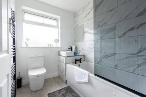 比斯顿2 Bedroom House in Chilwell - Perfect for Families and Business的白色的浴室设有浴缸和水槽。