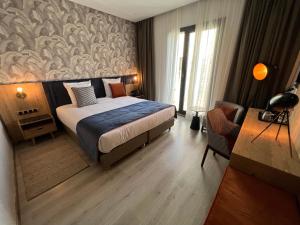丹吉尔Hotel Ben Batouta - Tanger的配有一张床和一张书桌的酒店客房