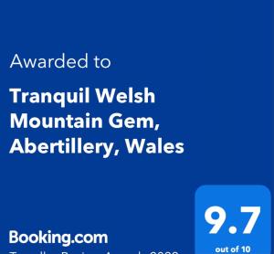 AbertilleryTranquil Welsh Mountain Gem, Abertillery, Wales的手机的屏幕,带有文字,希望移植威尔士山区细菌