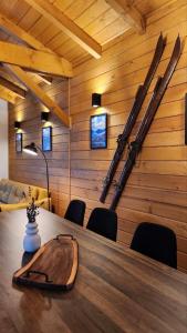 戈韦达尔齐HillVill的墙上设有一张桌子和滑雪板的房间