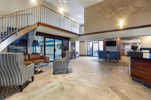 埃德蒙顿市中心贝斯特韦斯特优质酒店的客厅设有楼梯、沙发和椅子