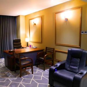 拉合尔Indigo Heights Hotel & Suites的一间配备有桌椅和沙发的等候室
