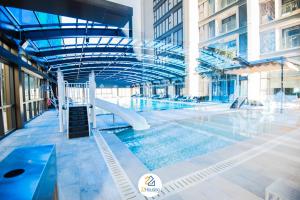 河内Royal Serviced apartment Vinhomes Metropolis的大楼内一个带滑梯的游泳池