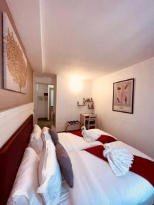 巴黎拉法叶特庭院剧场酒店的一间卧室配有两张带枕头的床。
