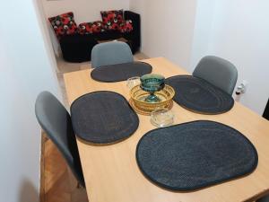 扎耶查尔Apartman 019的一张带椅子的木桌和一个花瓶