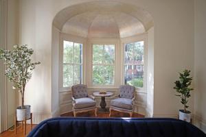 萨凡纳8BR Historic Hamilton House的带窗户的客房内配有两把椅子和一张桌子