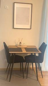 帕内韦日斯S&A apartamentai的餐桌、椅子和墙上的照片