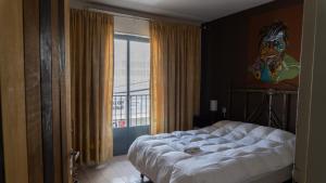 里瓦达维亚海军准将城Hotel Urbano Ventia的一间卧室配有一张壁画床