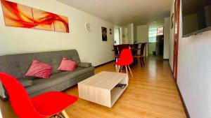 马尼萨莱斯Av santander apartamento perfecta ubicación的带沙发和红色椅子的客厅