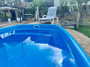 塞尔苏拉穆斯州长镇Espetacular! Casa em com vista deslumbrante的一个带桌子和椅子的蓝色游泳池
