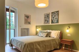 米兰Luxury 2 bedroom Apartament, close to San Siro, Fiera and 10 min metro to Duomo的一间卧室配有一张大床,墙上有两张照片