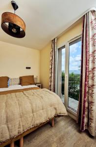 马莱莫尔Bastidon Golf de Pont Royal的一间卧室设有一张床和一个大窗户