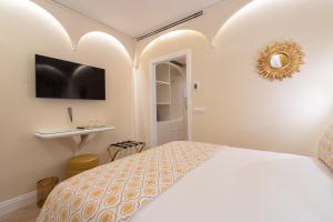 佛罗伦萨La Dimora del Mercante的白色卧室配有床和镜子